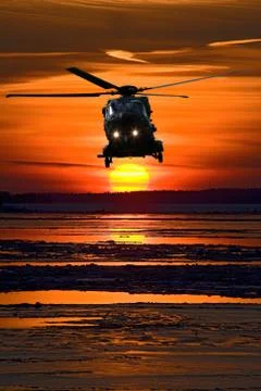 Helicopter at sunset Stock Photos