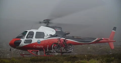 Helicopter take off in Mountains - high alpine summer bowl Stock Footage 133208398