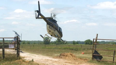 Helicopter taking off from grass field during day time, New Orleans, US Stock Footage 132395766