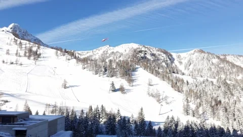 Helicopter Taking Off Over Snowy Ski Slope in Alpine Mountains Stock-Footage 331644394