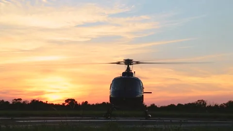 HELICOPTER TAKING OFF AT SUNSET Stock Footage 132951693