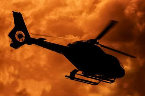 Helicopter taking off at sunset Stock Photos