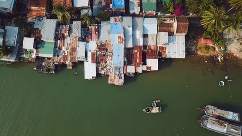 Helicopter topdown slums roofs river coast Asia rusty exotic fishing Vietnam Stock Footage 107041646
