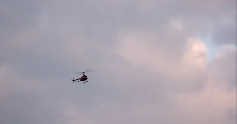 Helicopter tracked in front of white cloudy sky Stock Footage 67286480