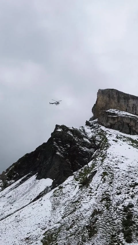 Helicopter Transporting Cargo Over Swiss Alps. Stock Footage 328462283