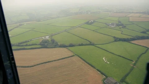 Helicopter view of British fields through cloud v2 Stock Footage 118266385