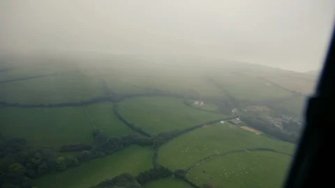 Helicopter view of British fields through cloud Stock Footage 118266529