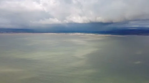 Helicopter view of heavy rainfall Storm showers over land mainland while flying Stock Footage 265457294