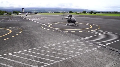 Helicopter waiting on landing pad Stock Footage 84083161