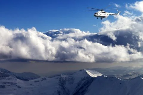 Helicopter in winter mountains Stock Photos