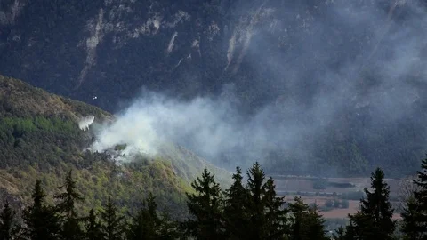 Helicopters fighting forest fire between Sion and Lens, Switzerland. April 2017. Video stock 75160502