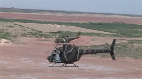 Helicopters fly in formation over desert Stock Footage 45550545