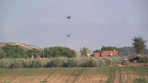 Helicopters taking off from a far Stock Footage 76917351