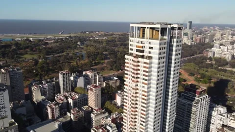 Helix Shot Of Le Parc Skyscraper In Buenos Aires City, River In Video stock 230866398