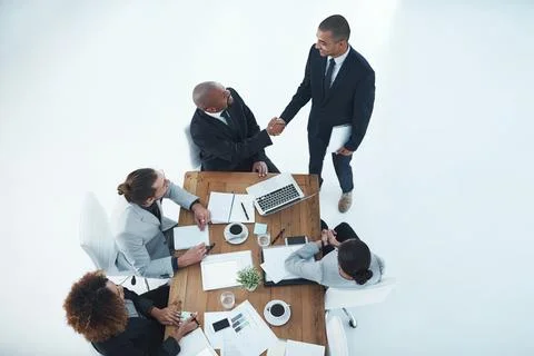 Hell brings some fresh ideas to the team. two businesspeople shaking hands in a Stock Photos
