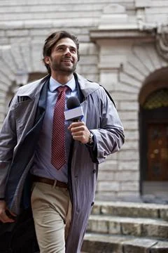 Hell find the story. Shot of a handsome young news reporter. Stock Photos