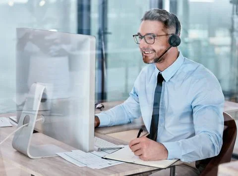 Hell help you swiftly with all inquiries. a mature call centre agent writing Stock Photos