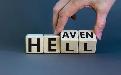 Hell or heaven. Hand turns cubes and changes the word 'hell' to 'heaven'. Con Stock Photos