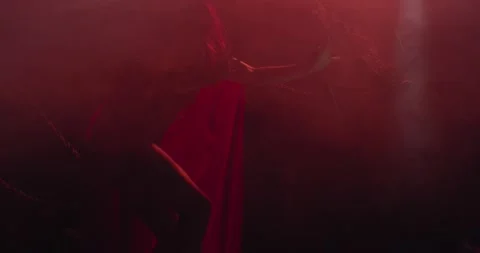 Hell, red lighting and lots of smoke, succubus is moving in the dark, 4k Stock Footage 136788824