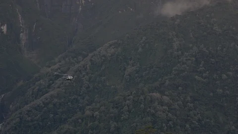 Hellicopter arriving in the mountains Stock Footage 121664825