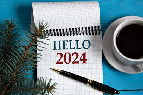 HELLO 2024 - words in a white notebook on the background of a cup of coffee.. Stock Photos