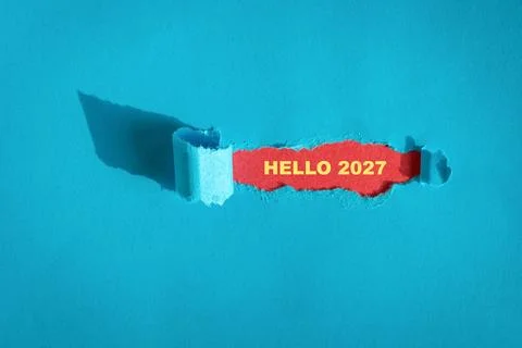 Hello 2027 message behind torn hole Stock Photos