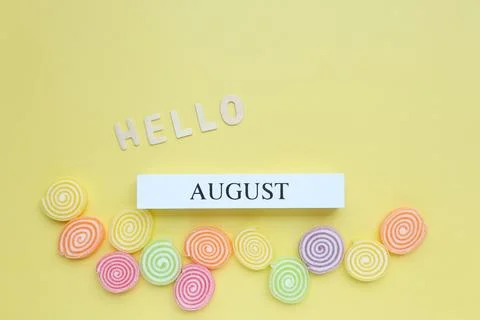 Hello August, August text on white wood block and jelly sweet Stock Photos