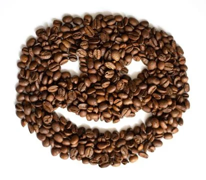 Hello coffee. Closeup of roasted coffee beans with smile on white background Stock Photos