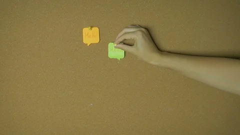 Hello. Conversation in chat or messenger. Hands pining sticky notes on pin board Stock Footage 98851927