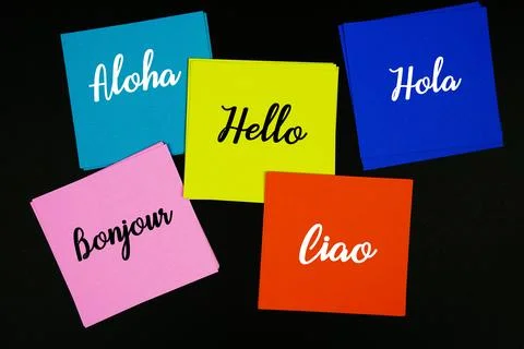 Hello in Difference Language text message on stick note on black background Stock Photos