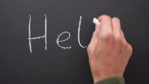 Hello handwritten with chalk on black board Stock Footage 285949834