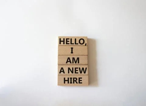 Hello I am a new hire symbol. Concept words Hello I am a new hire on wooden.. Stock Photos