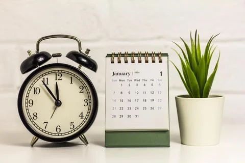 Hello January. On the table is a calendar for January 2024. Stock Photos