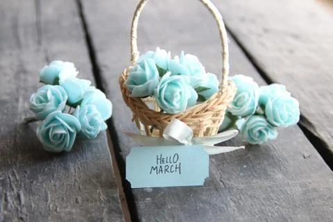 Hello March. Rustic still life, roses and tag, vintage table Stock Photos