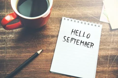 Hello september text on notepad with cup of  coffee Stock Photos