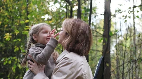 Hello September. A young mother and little daughter walk in the city park in Stock Footage 239085896