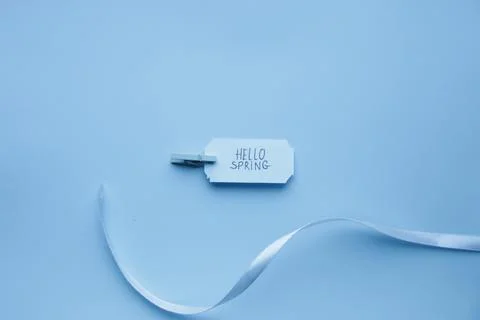 Hello Spring idea. lettering on a blue tag. Stock Photos