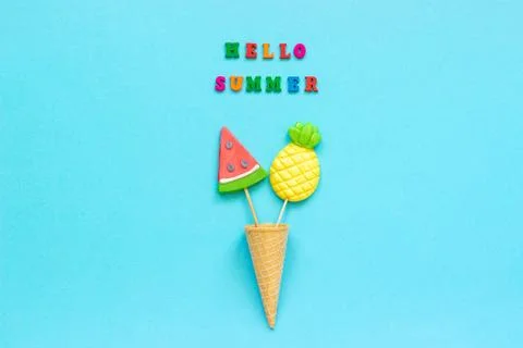 Hello summer colorful text, pineapple and watermelon lollipops in ice cream w Stock Photos