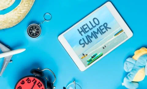 Hello Summer poster on tablet with summer travel accessories Stock Photos