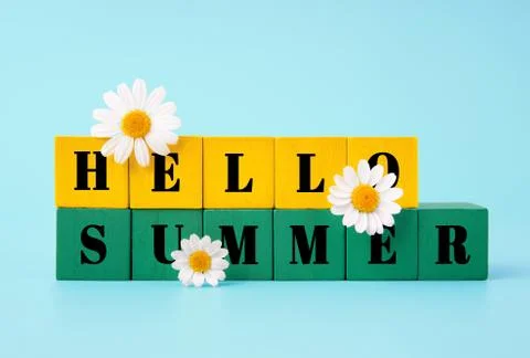 Hello Summer text written on two rows of yellow and green wooden cubes Stock-Fotos