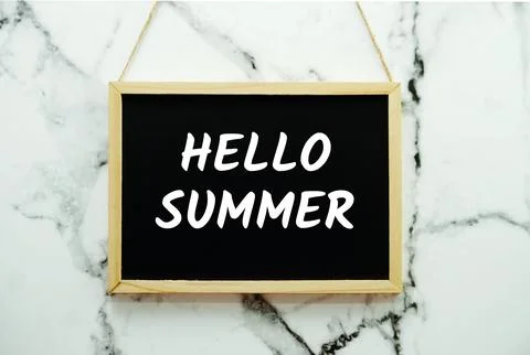 Hello Summer typography text on blackboard hanging against on the wall back.. Stock Photos