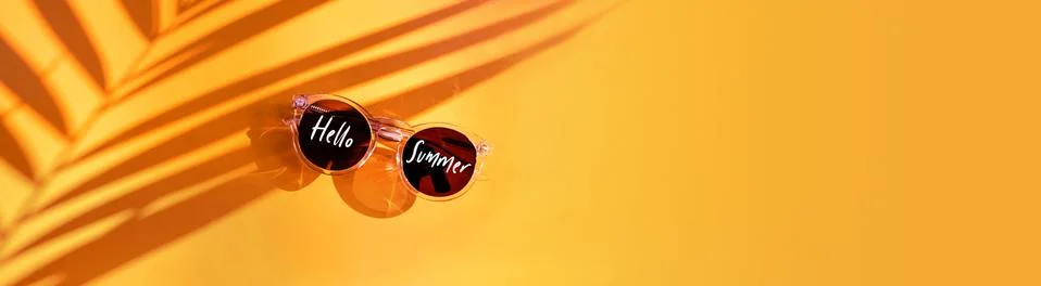 Hello summer word on Palm leaf shadow with summer sunglasses on yellow backgr Stock Photos