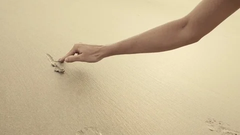 HELLO SUMMER written on the beach sand washed aways by waves. Stock Footage 77875097