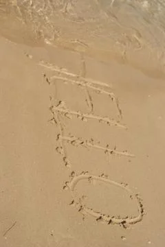 Hello word in the sand at the beach Stock Photos