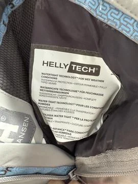 Helly Hansen jacket tag showing Helly Tech technology details for waterproo.. Stock Photos