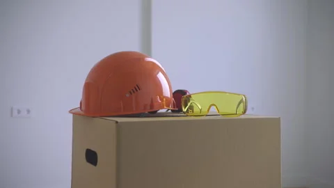 Helmet and Glasses while working on the moving box. Stock Footage 313679211