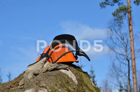 Helmet and gloves on a rock Stock Photos