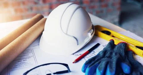 Helmet, architecture and tools in empty office with engineering gloves, blu.. Stock Photos