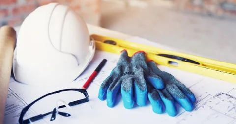 Helmet, architecture and tools in empty office for construction gloves, blu.. Stock Photos