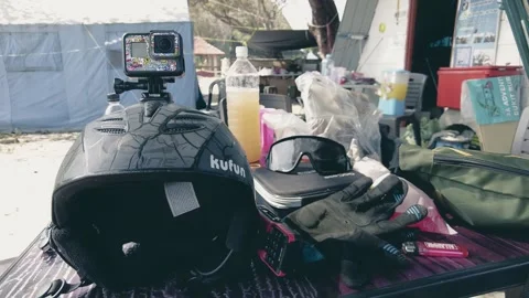 Helmet with attached action camera and other gears for paragliding on the table. 動画素材 241118898